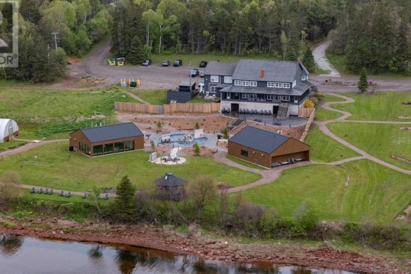 Aerial view of a complex with multiple buildings, a pool, and landscaped grounds. - Lot 6 Sonora Road, St  Peters Bay