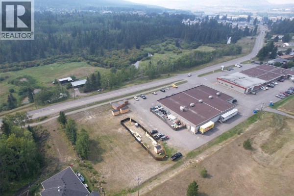 Aerial view of commercial area with parking and surrounding trees. - Lot 7-110 Forest Ridge Road, 100 Mile House