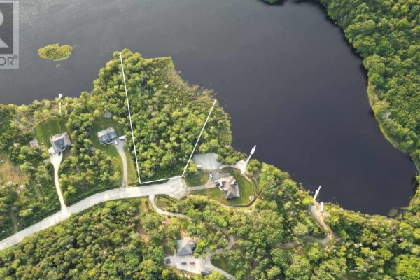 Aerial perspective of the surrounding landscape, showcasing homes, trees, and a dark water body. - Lot 7 Ruelle Gardner Lane, Tusket