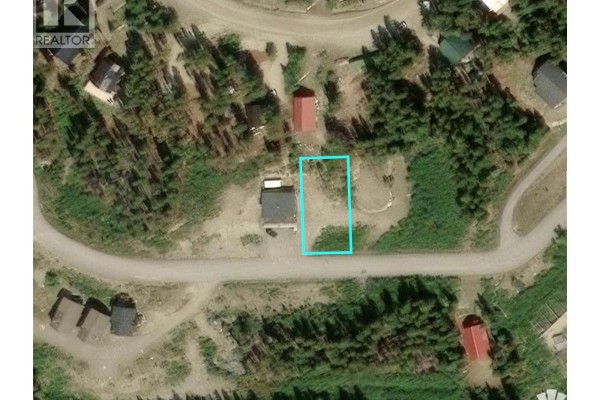 Aerial view of a small lot highlighted in blue, with a building and surrounding trees. - Lot 8 Buck Road, Oliver