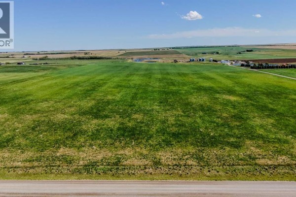 Aerial perspective of a rural property showing fields and farm buildings. - Lot 8, Magrath