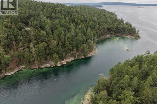 Aerial view of a narrow channel of clear water between forested land and rocky shore. - Lot 8 Ruxton Island, Ruxton Island