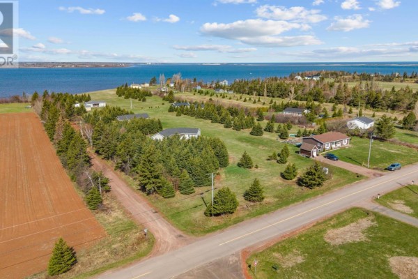 Aerial view showing houses, trees, and fields leading to a large body of water. - Lot 855 Blooming Point Road, Rte 218, Blooming Point