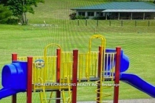 A colorful children's playground structure with blue, yellow, and red components. - Lot 88 - 248 Pinnacle Hill Road, Alnwick/haldimand