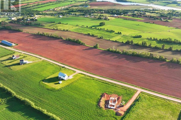 Aerial view of a rural property showing fields, houses, a pond, and an incomplete building foundation. - Lot 9 Scenic View Road, Long Creek