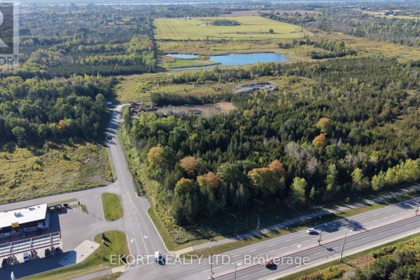 Aerial view of wooded land parcels with a distant view of agricultural fields and water. - Lot B & C Jenland Way S, Belleville