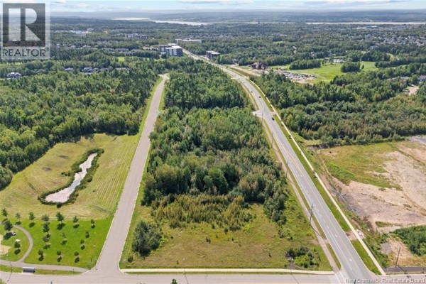 Aerial view of a wooded lot and surrounding landscape with distant buildings. - Lot Dieppe Boulevard And Yvonne, Dieppe