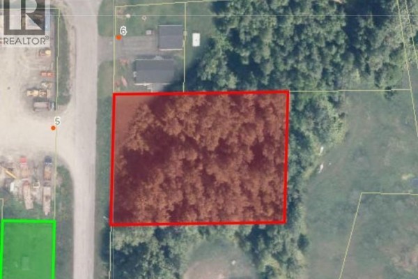 Aerial view of a rectangular lot outlined in red, covered with trees, next to a road. - Lot Gagnon Street, Kedgwick