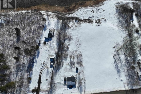 Clear view of the waterfront lot with a field and trees along the shoreline. - Lot Granville Road, Port Wade