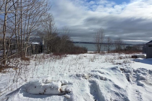 Scenic view of the shoreline with trees and nearby homes along the water's edge. - Lot Granville Road, Port Wade