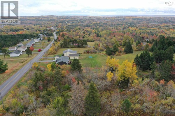 Aerial view of a wooded area with homes and colorful autumn foliage, overlooking a town. - Lot Greenhill Road, Alma