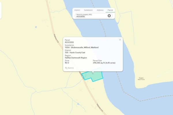 Small blue and brown wellhead in a densely wooded area with leaf-covered ground. - Lot Highway 215, South Maitland