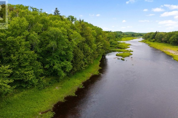 Scenic view of a river bordered by trees and grassy areas under a clear blue sky. - Lot Lead Mines Road, Glenelg