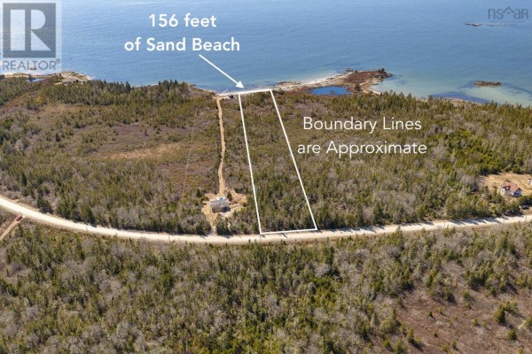 Aerial view of a wooded property with a dirt road leading to a small building and ocean in distance. - Lot Mb-1 Rockland Road, East Side Of Ragged Island