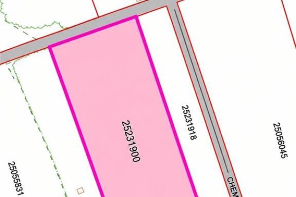 Aerial view of a rectangular property outlined in pink, with road frontage and adjacent lots. - Lot Mcdonald, Saint Maurice