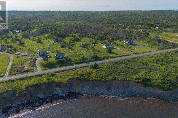 Aerial view of coastal land with houses, fields, and the ocean. - Lot Mines Drive Road, Port Morien