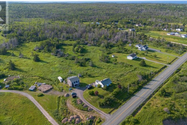 Aerial view of property with houses, outbuildings, and a paved road. - Lot Mines Drive Road, Port Morien