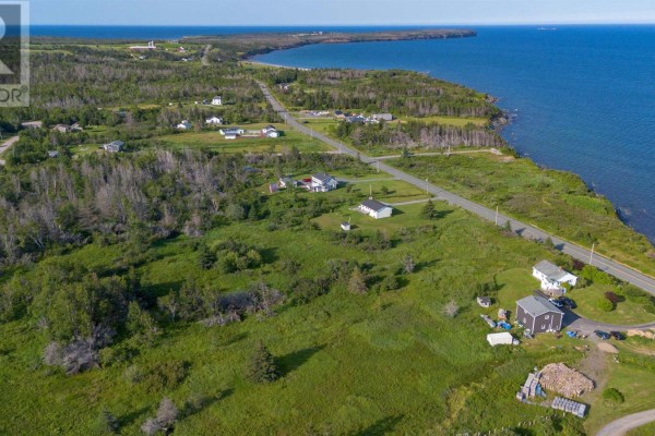 Aerial view of coastal area with houses, fields, ocean, and distant land. - Lot Mines Drive Road, Port Morien