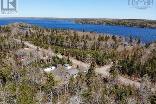 Aerial view of Kill Dog Cove Road with several homes, RVs, and a large blue lake. - Lot R-11 Kill Dog Cove Road, Parkdale