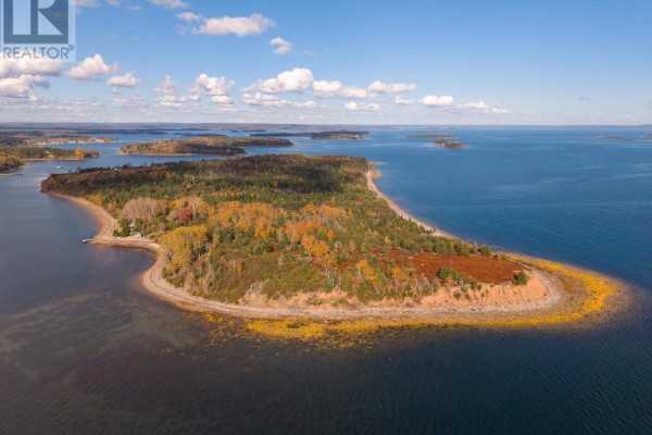 Expansive aerial view of Lot Rous Island, showing the wooded peninsula extending into the blue ocean. - Lot Rous Island, Indian Point