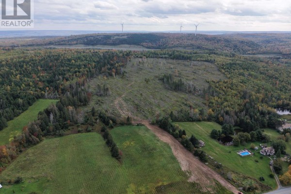 Expansive aerial view of cleared land with wind turbines and surrounding forests. - Lot Tanner Hill Road, Limerock
