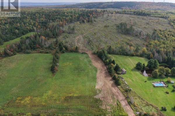 Aerial view of cleared land, a small pond, a swimming pool, and a house. - Lot Tanner Hill Road, Limerock