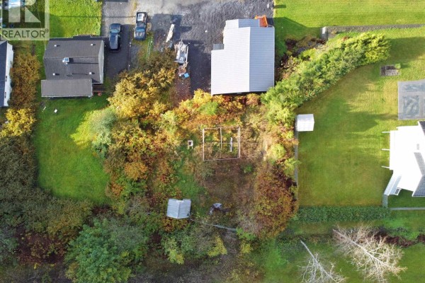 Bird's-eye view of the property featuring a garden area, surrounded by greenery and residential homes. - Lots 5 & 6 E 8th Avenue, Prince Rupert