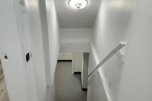 Staircase view with a light fixture, leading down to a lower level. - Lower - 357 Main Street E, Hamilton
