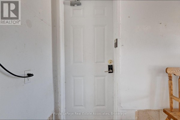 Interior view of a white door with a keypad lock and an electrical outlet. - Lower - 41 Greenview Circle, Vaughan