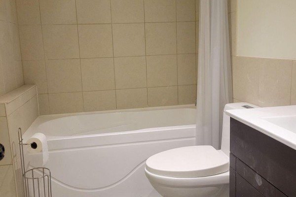 Open room with light yellow walls, baseboards, and light wood laminate flooring. - Lower - 42 Ambleside Crescent, Markham