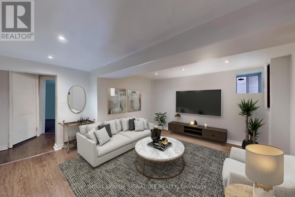 Living room featuring a sectional sofa, marble coffee table, and a media console with a television. - Lower - 553 Euclid Avenue, Toronto