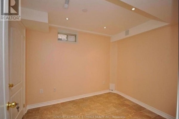Unfurnished basement room with peach walls, tile floor, and small window. - Lower - 5689 Sidmouth Street, Mississauga