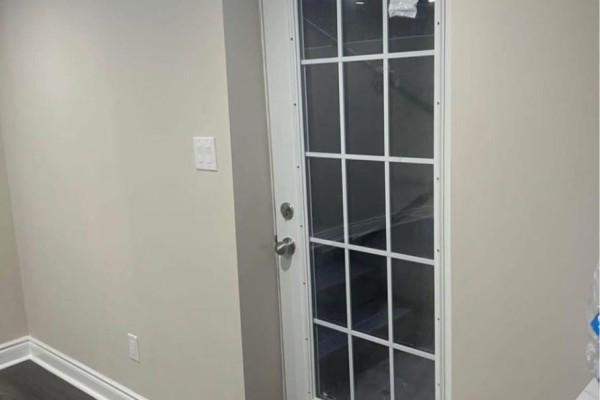 Interior view of a door with glass panes leading to a staircase. - Lower - 59 Edwina Court, Hamilton