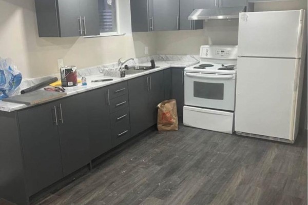 Kitchen area with dark grey cabinets, white countertops, and white appliances. - Lower - 59 Edwina Court, Hamilton