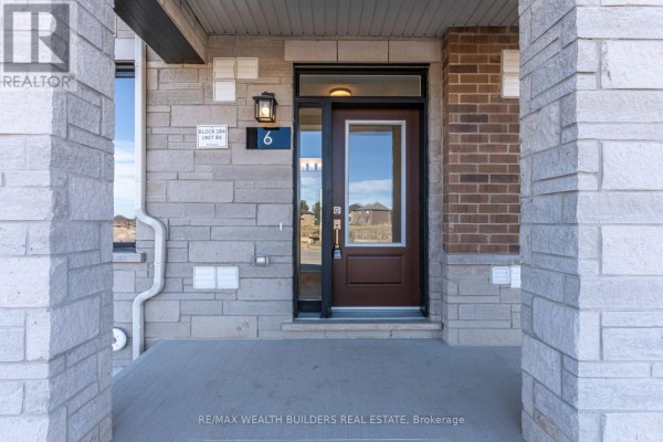 Front door entrance to unit 6 with dark brown door and black window frame. - Lower - 6 Thornbird Crescent, Brampton