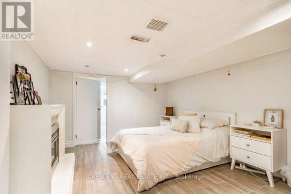 Bedroom with white furniture, desk, and a view of the door. - Lower - 603 Saint Clarens Avenue, Toronto
