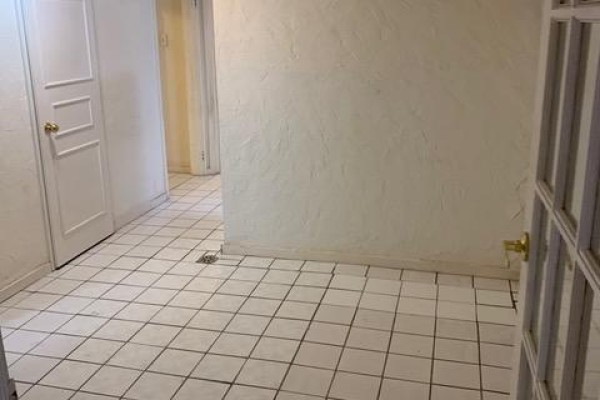 Room with white checkered tile floor, textured walls, and white paneled doors. - Lower - 730 Logan Avenue, Toronto