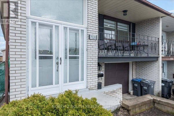 Close-up of the double front doors with glass inserts and a covered porch. - Lower - 7520 Langworthy Drive, Mississauga