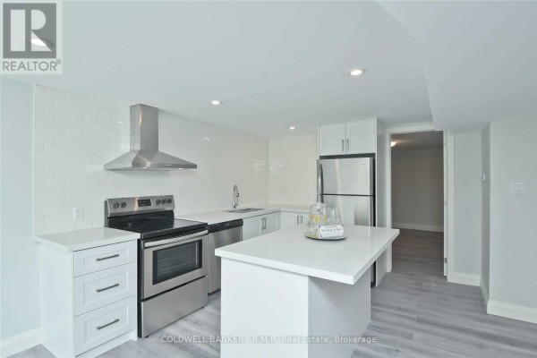 Updated kitchen with white cabinetry, quartz countertops, and stainless steel appliances. - Lower - 760 Ashley Court, Oshawa