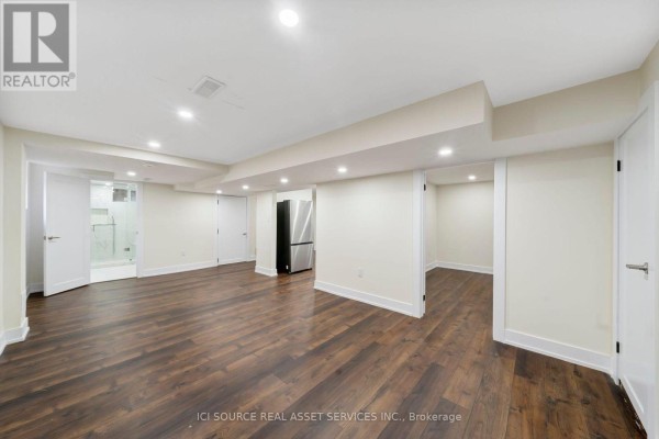 Open layout of the lower level featuring a kitchen area and staircase - Lower - 78 Leaside Drive, St  Catharines