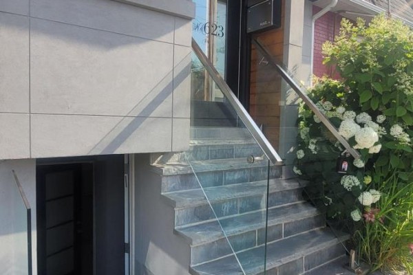 Exterior stone steps with modern glass and stainless steel railings. - Lower Level - 623 Dupont Street, Toronto