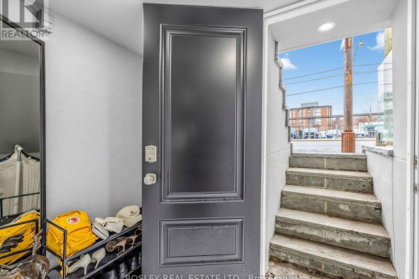 View from inside a room looking out to concrete steps and street. - Lower Level - 623 Dupont Street, Toronto