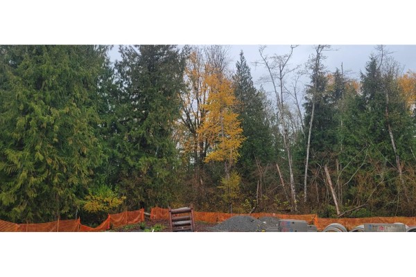 Construction site with gravel, trees, and orange safety fencing in the background - Lt. 583 Stephen Leacock Drive, Abbotsford
