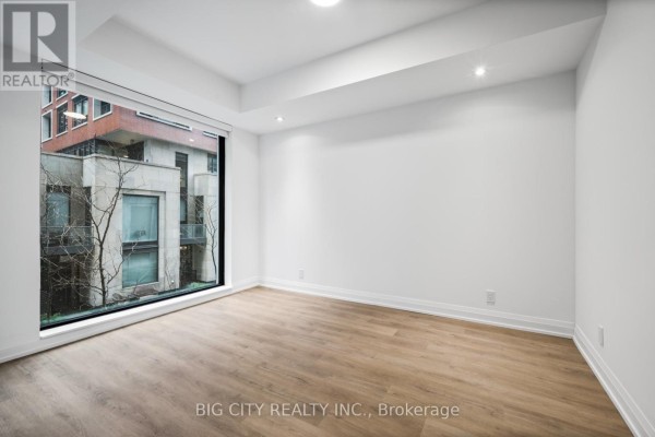 Exterior view of a modern condominium building with multiple levels and balconies. - M04 - 36 Brentcliffe Road, Toronto