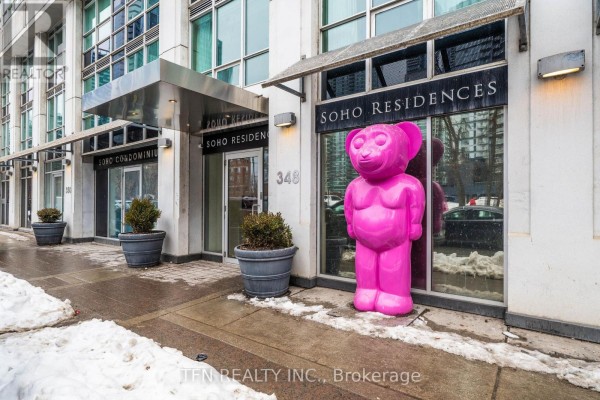 Entrance to M22 - 350 Wellington Street W apartments with a large pink bear sculpture. - M22 - 350 Wellington Street W, Toronto