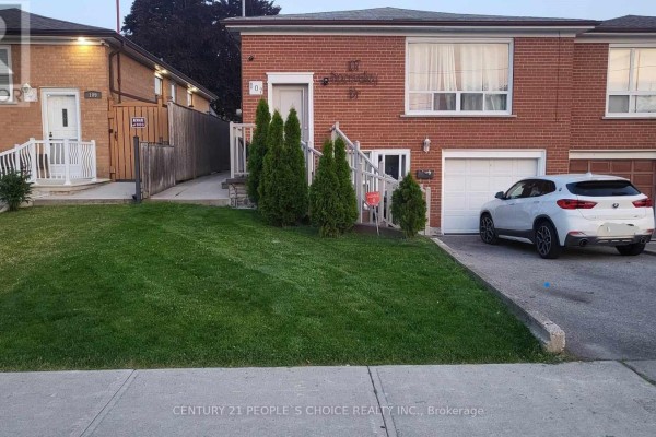 Exterior view of a brick semi-detached house with a driveway and garage. - Main - 107 Spenvalley Drive, Toronto