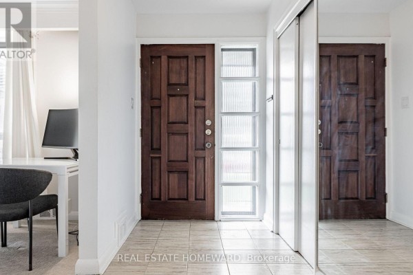 Entranceway with two dark wood paneled doors and a frosted glass sidelight. - Main - 11 Greenbriar Road, Toronto