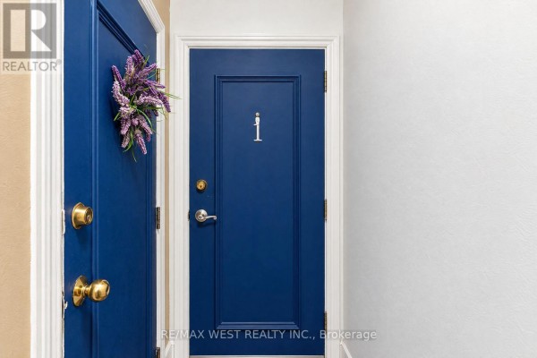 Interior hallway with two painted blue doors and gold hardware. - Main - 203 Islington Avenue, Toronto