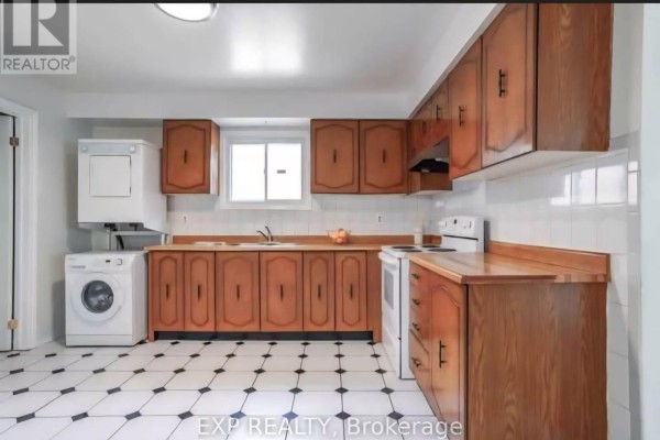 Kitchen featuring wooden cabinets, a white range, and a window overlooking the sink. - Main - 26 Greenleaf Terrace, Toronto