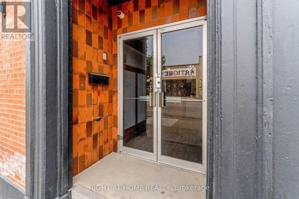 Close-up of double glass doors with orange tile surround and a black mailbox. - Main - 262 Ottawa Street N, Hamilton